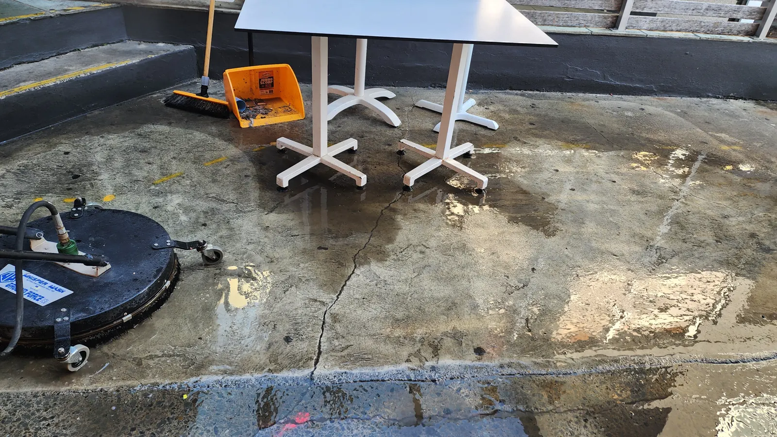 Commercial dining courtyard half cleaned, showing the clean line