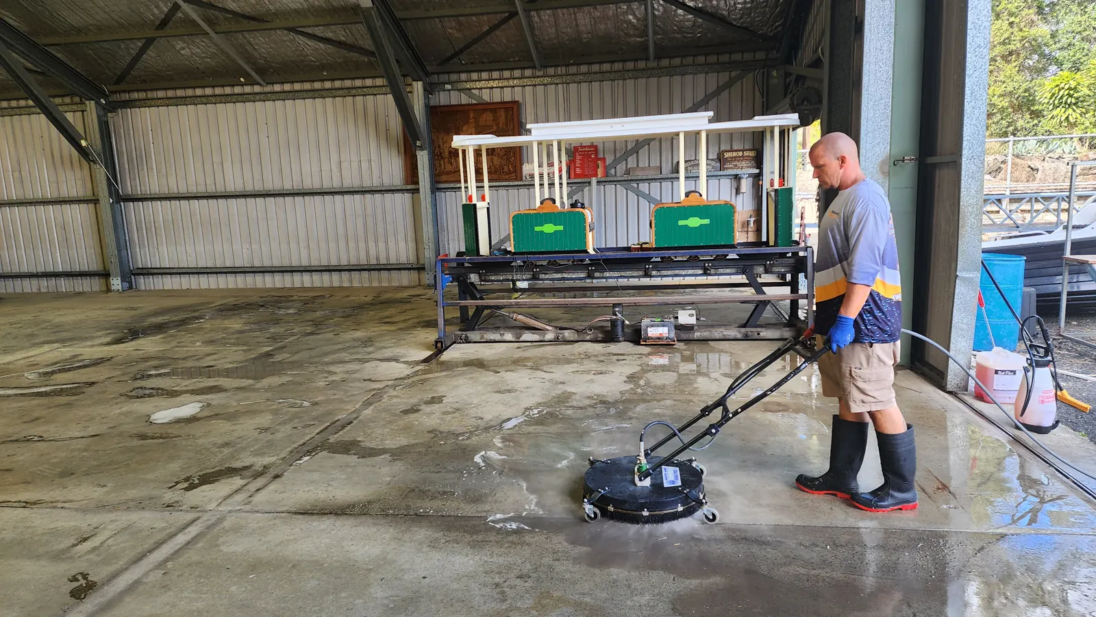 ThermoBlast operator running a surface cleaner on a warehouse floor