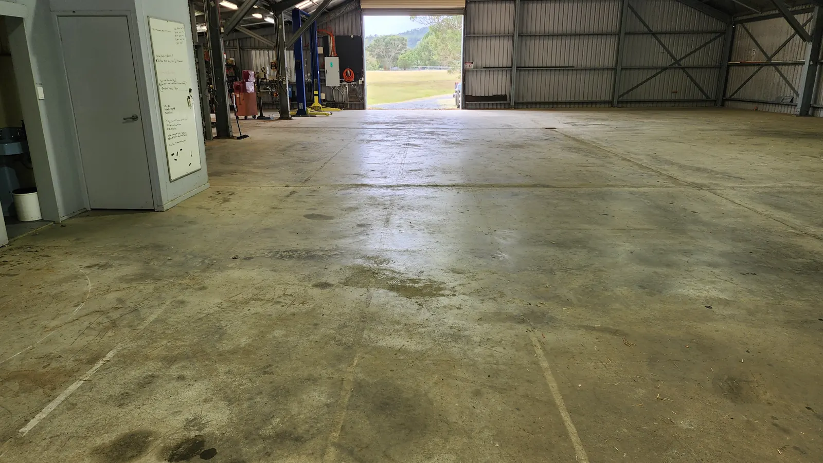 Oil stained warehouse floor before ThermoBlast cleaning